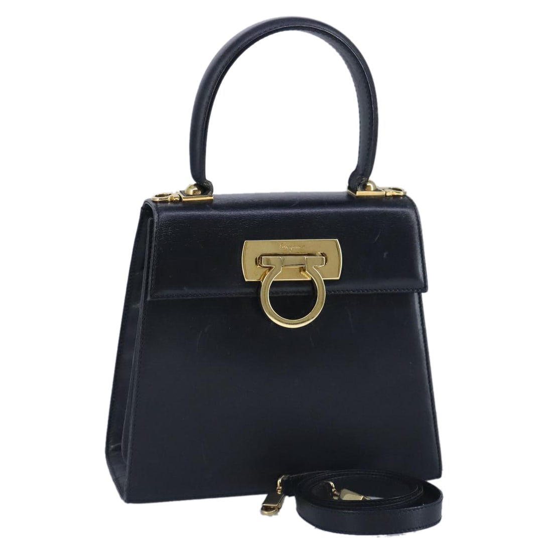 Salvatore Ferragamo Gancini Navy Leather Handbag Made in France: Salvatore Ferragamo Gancini Navy Leather Handbag Made in France This Salvatore Ferragamo Gancini handbag showcases a stylish navy leather exterior, ideal for the modern woman. Designed with a structur