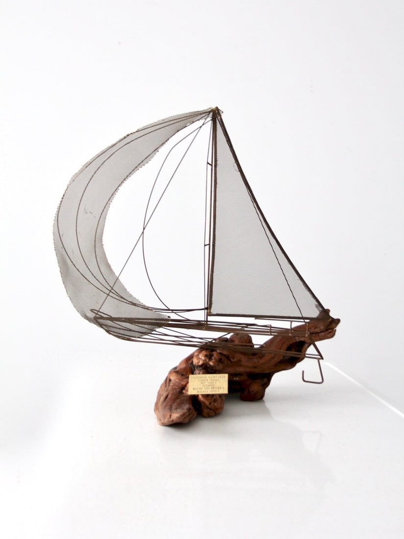 Heritage Collection Brass Driftwood Sailboat Sculpture 1977 Tanner Series: Heritage Collection Brass Driftwood Sailboat Sculpture 1977 Tanner Series This hand-crafted vintage sailboat sculpture from our Heritage Collection beautifully combines artistic design with natural ma