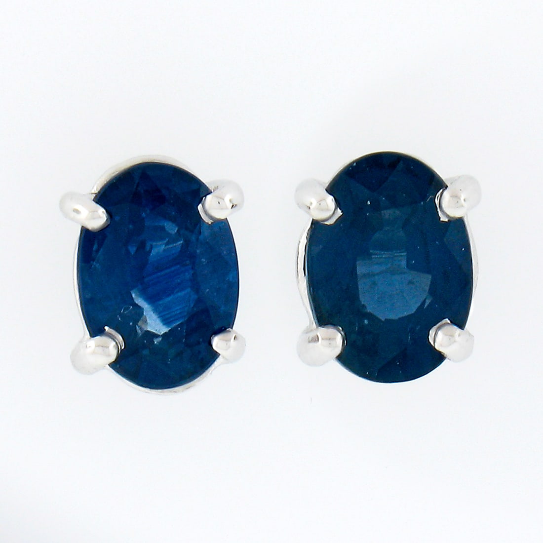 Elegant 14K White Gold 1.32ct Oval Blue Sapphire Stud Earrings: Elegant 14K White Gold 1.32ct Oval Blue Sapphire Stud Earrings Elevate your style with these exquisite stud earrings crafted in solid 14K white gold. Featuring two stunning oval brilliant cut sapphire