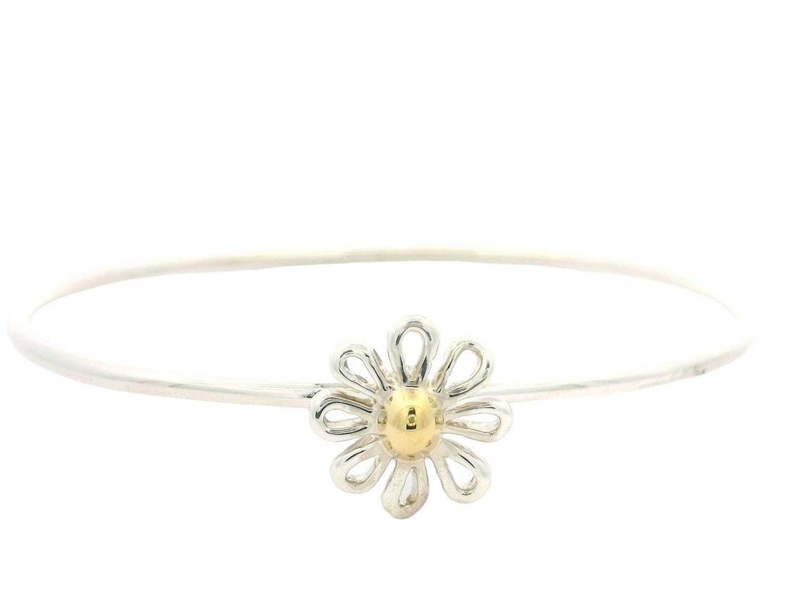 Tiffany & Co. Paloma Picasso 18k Gold Daisy Flower Bangle Bracelet: Tiffany & Co. Paloma Picasso 18k Gold Daisy Flower Bangle Bracelet This exquisite Tiffany & Co. bracelet features a distinctive Paloma Picasso design, showcasing a beautiful daisy flower motif. Crafte