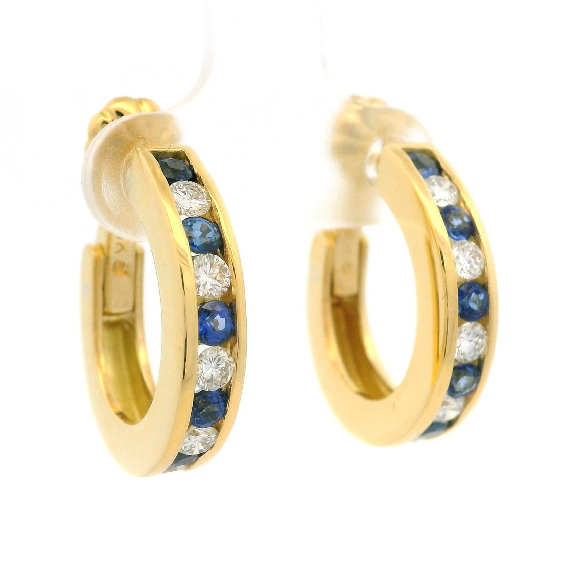 Elegant 18k Yellow Gold Sapphire Diamond Cuff Huggie Hoop Earrings: Elegant 18k Yellow Gold Sapphire Diamond Cuff Huggie Hoop Earrings These stunning 18k yellow gold cuff huggie hoop earrings showcase a dazzling combination of blue sapphires and sparkling diamonds. Th