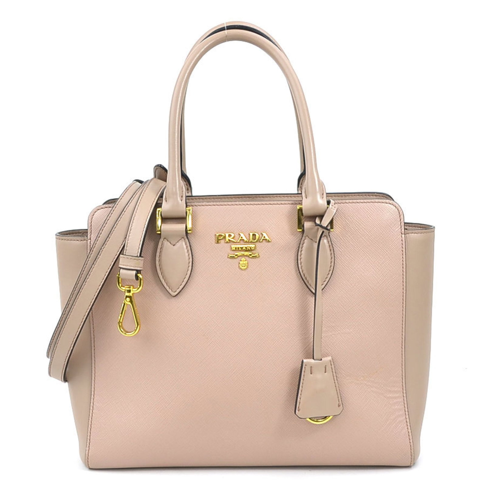 Prada Pink Beige Leather Shoulder Bag 21cm x 26cm x 9cm: Prada Pink Beige Leather Shoulder Bag 21cm x 26cm x 9cm This exquisite Prada handbag, designed for women, showcases a sophisticated blend of pink and beige leather. With dimensions of 21cm x 26cm x 9c