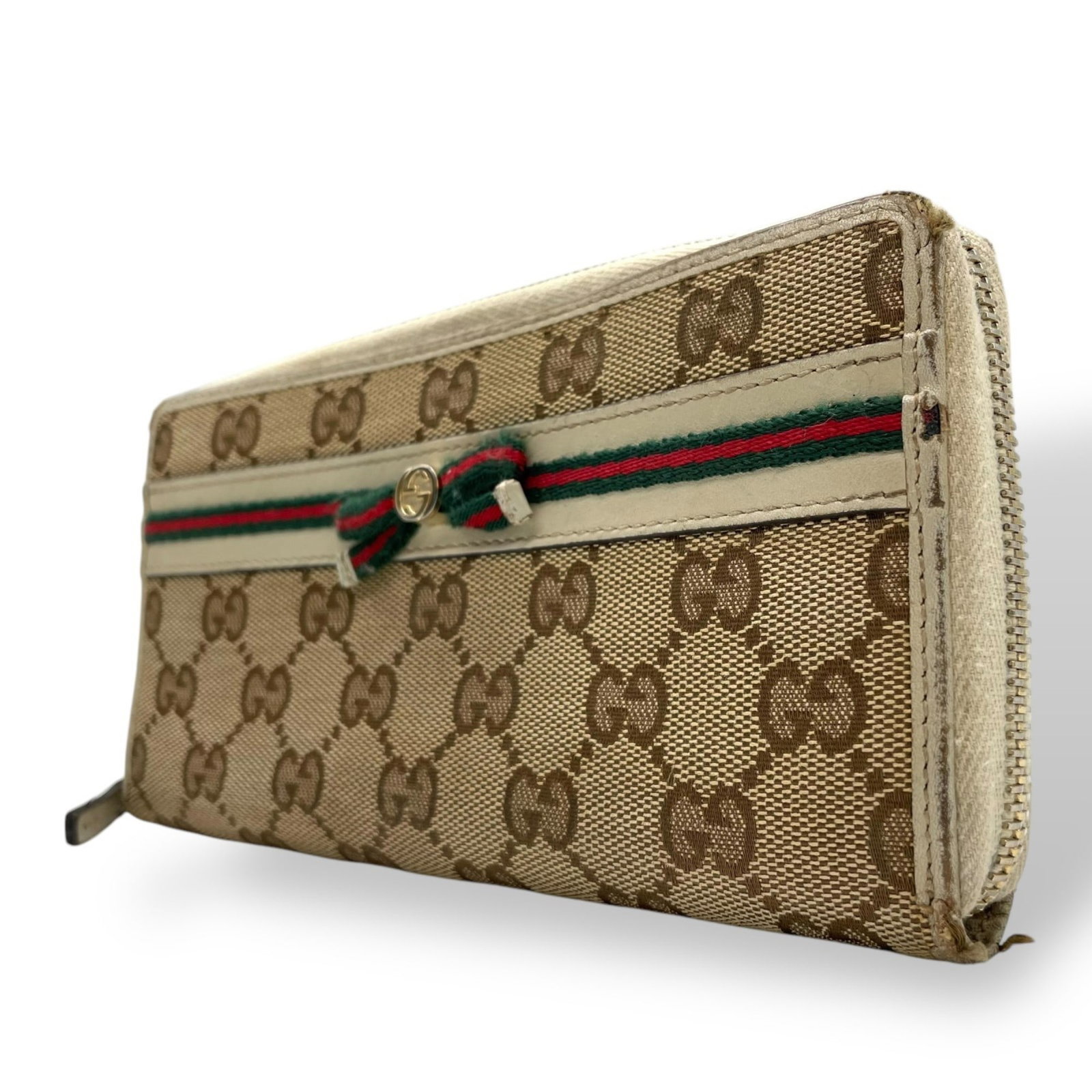 Gucci GG Canvas Long Wallet with Round Zipper and Sherry Ribbon: Gucci GG Canvas Long Wallet with Round Zipper and Sherry Ribbon This Gucci long wallet is a stylish accessory crafted from GG canvas and leather, featuring a round zipper design. Designed for women, i