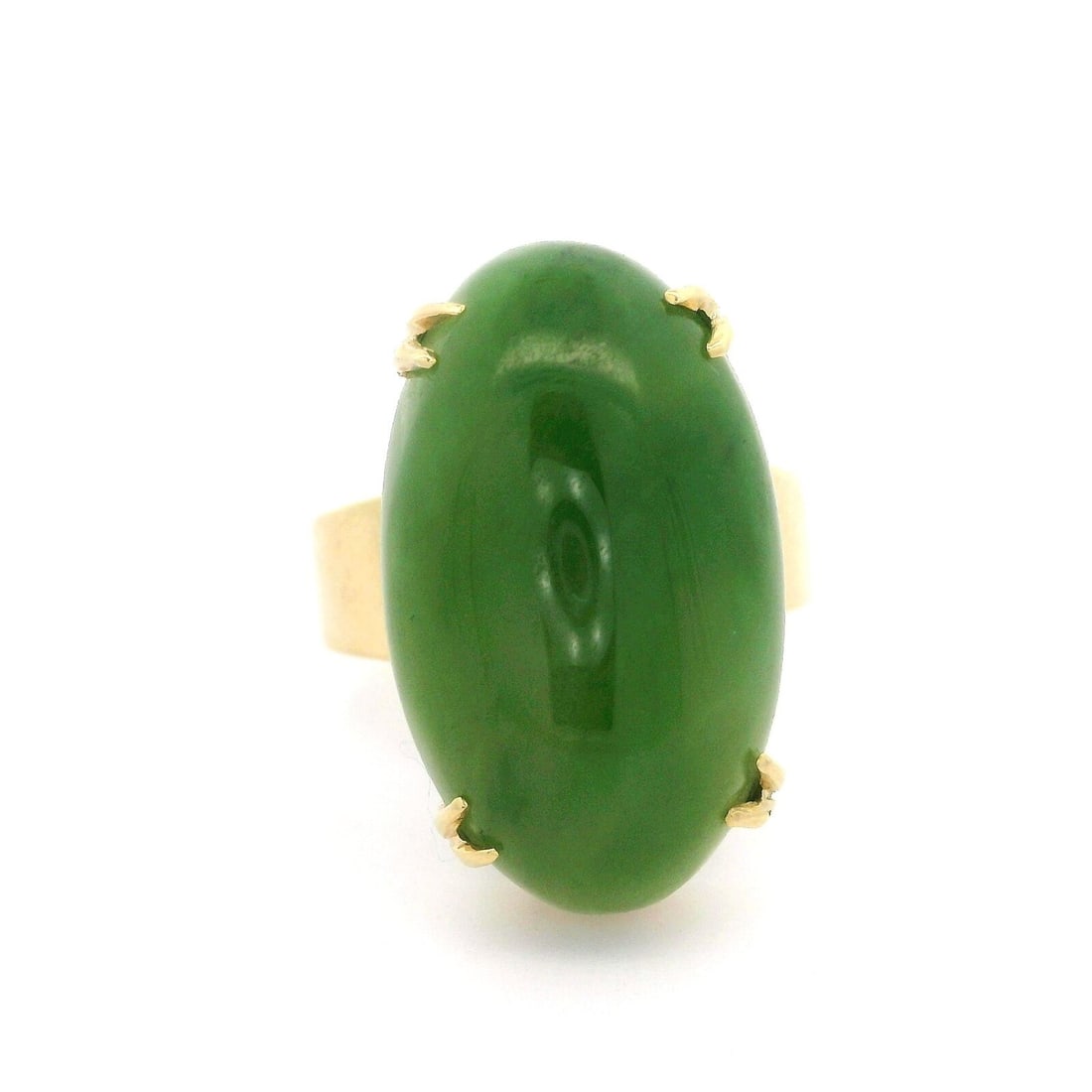 Vintage 14k Yellow Gold Jade Cabochon Cocktail Ring: Vintage 14k Yellow Gold Jade Cabochon Cocktail Ring This stunning vintage cocktail ring features an oval cabochon cut jade stone, elegantly set in rich 14k yellow gold. The jade showcases a beautiful 