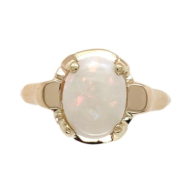 Vintage 9k Yellow Gold Multicolor Opal Ring Size 6.75: Vintage 9k Yellow Gold Multicolor Opal Ring Size 6.75 This exquisite vintage ring features a stunning genuine natural Australian opal set in 9k yellow gold. The oval opal, measuring approximately 9mm 