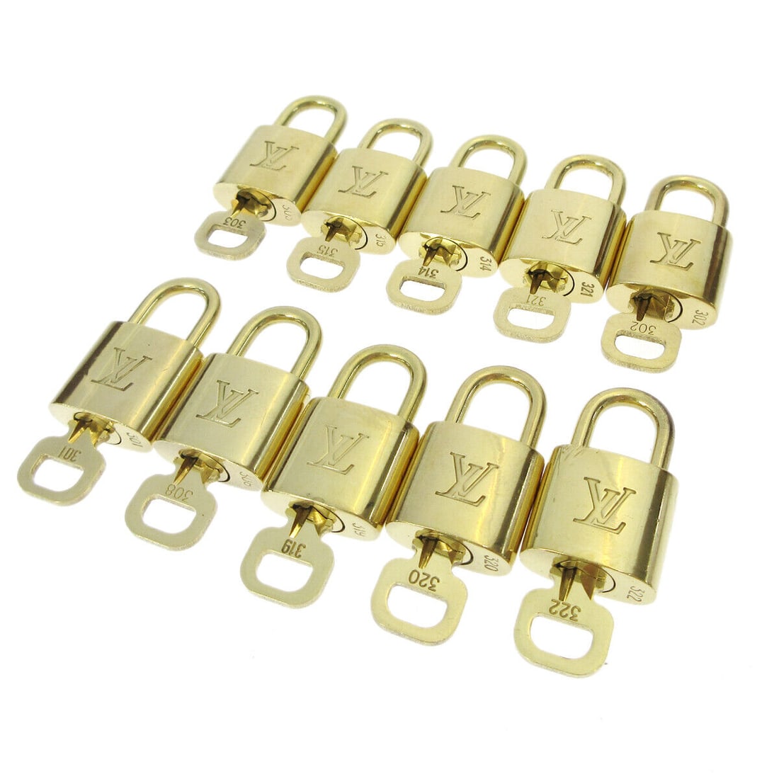 Louis Vuitton Gold Padlock & Key Bag Accessories 10 Piece Set: Louis Vuitton Gold Padlock & Key Bag Accessories 10 Piece Set Enhance your Louis Vuitton collection with this exquisite 10-piece set of Padlock & Key Bag Accessories Charm. Crafted in a luxurious gold