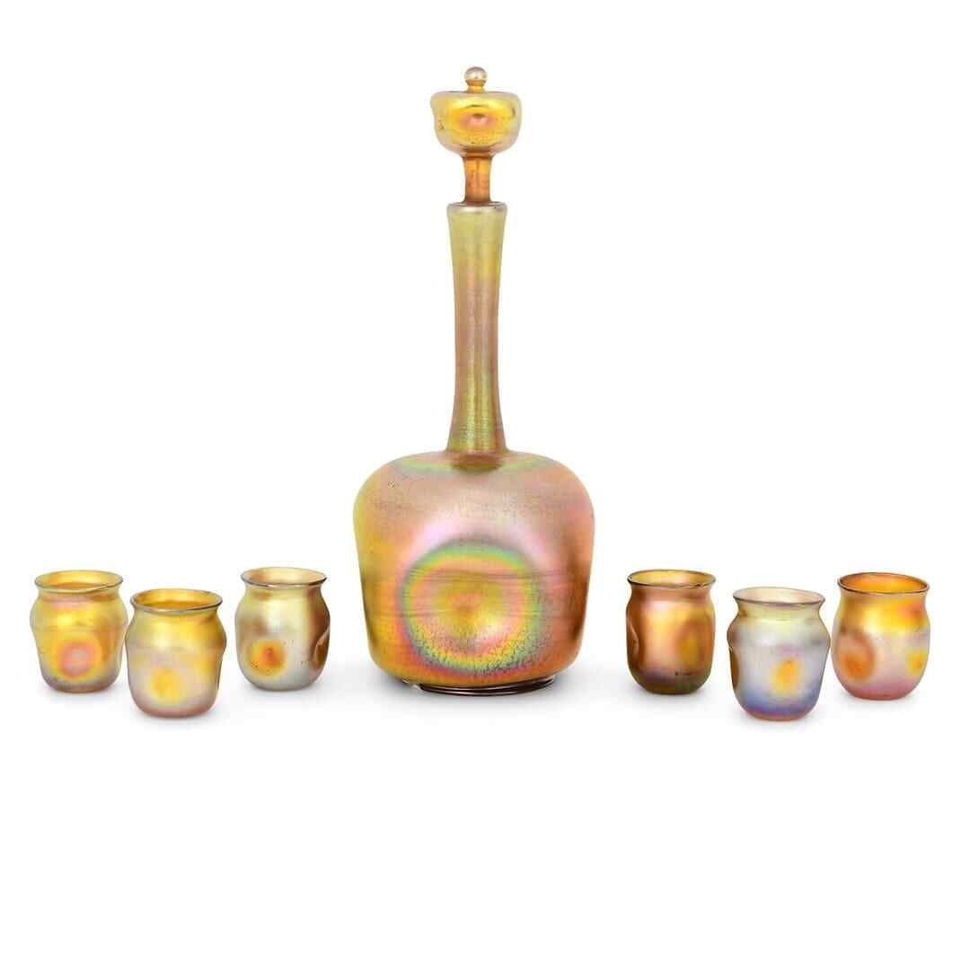 Tiffany Studios 7-Piece Favrile Glass Decanter Set Circa 1915: Tiffany Studios 7-Piece Favrile Glass Decanter Set Circa 1915 Enhance your collection with this exquisite 7-piece decanter set by Tiffany Studios, crafted from Favrile glass circa 1915. The elegantly