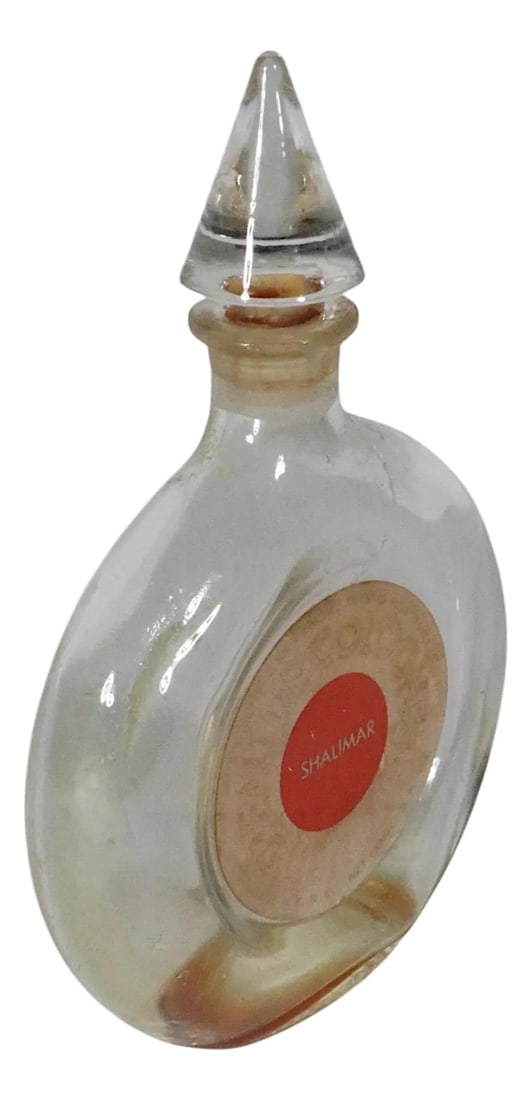 Vintage Guerlain Shalimar Perfume Bottle Glass 3.75x3.75x5.75: Vintage Guerlain Shalimar Perfume Bottle Glass 3.75x3.75x5.75 This exquisite Vintage Shalimar Perfume Bottle from Guerlain dates back to the period between 1930 and the 1970s. It is crafted from trans
