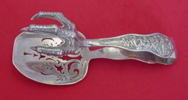 Tiffany & Co Olympian Sterling Silver Ice Tongs 5 1/2" Chicken Claw: Tiffany & Co Olympian Sterling Silver Ice Tongs 5 1/2" Chicken Claw Elevate your dining experience with these exquisite ice tongs from Tiffany & Co. Crafted in the renowned Olympian pattern, these ste