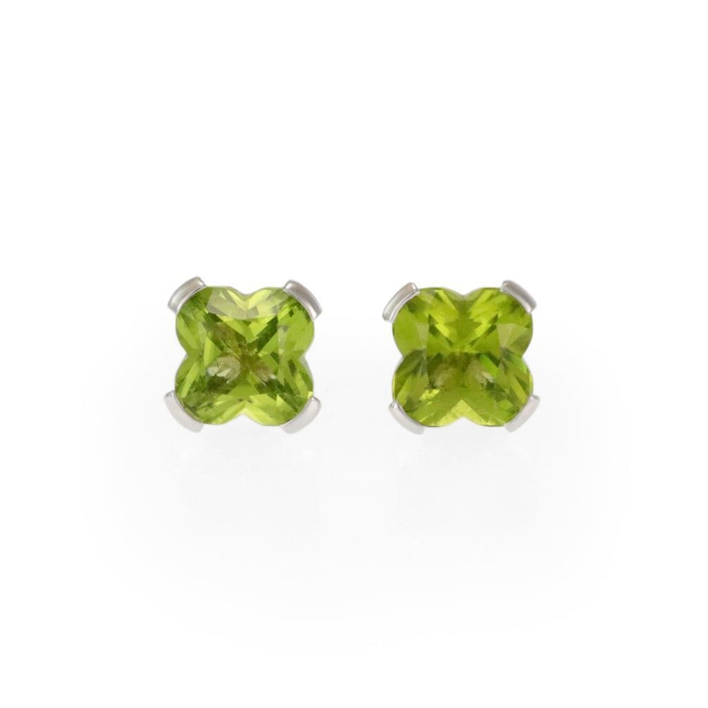 Mauboussin Paris 3ct Flower Cut Peridot Earrings 18k White Gold Studs: Mauboussin Paris 3ct Flower Cut Peridot Earrings 18k White Gold Studs Elevate your jewelry collection with this exquisite pair of stud earrings by Mauboussin Paris. Crafted from luxurious 18k white go