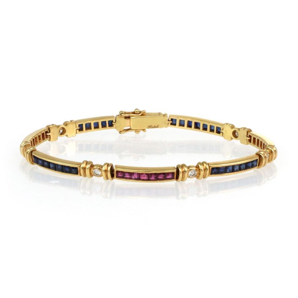 Elegant 18k Yellow Gold Diamond Ruby Sapphire Bracelet 3.30ct: Elegant 18k Yellow Gold Diamond Ruby Sapphire Bracelet 3.30ct This stunning bracelet, crafted from 18k yellow gold, showcases a series of seven long, slim curved bars. Each bar is elegantly set with a