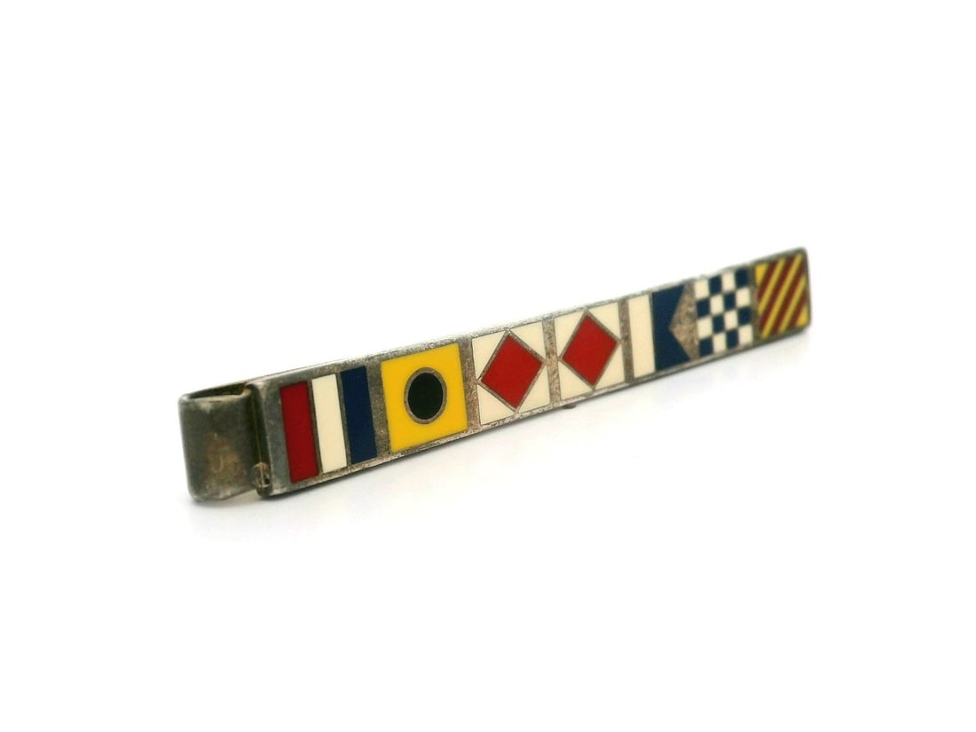 Tiffany & Co. Sterling Silver Nautical Flags Enamel Tie Bar: Tiffany & Co. Sterling Silver Nautical Flags Enamel Tie Bar Elevate your style with this exquisite tie bar from Tiffany & Co., crafted from high-quality sterling silver. The tie bar features vibrant n