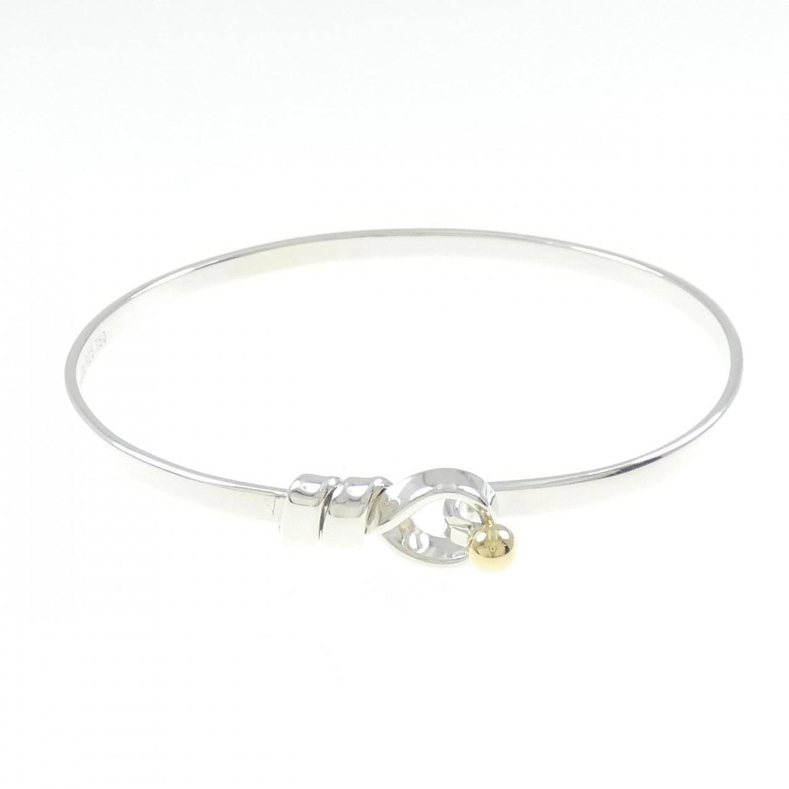 Tiffany Love Knot Bangle in Silver 925 and 18K Yellow Gold: Tiffany Love Knot Bangle in Silver 925 and 18K Yellow Gold This exquisite Tiffany Love Knot Bangle is a perfect blend of elegance and craftsmanship. Made from high-quality Silver 925 and featuring 18K