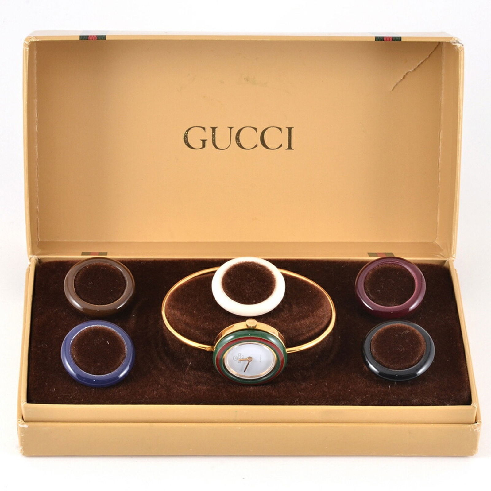 GUCCI Ladies Gold Plated Changeable Bezel Quartz Watch White Dial: GUCCI Ladies Gold Plated Changeable Bezel Quartz Watch White Dial This elegant GUCCI ladies' wristwatch features a changeable bezel design, allowing you to customize its look with six vibrant colors.