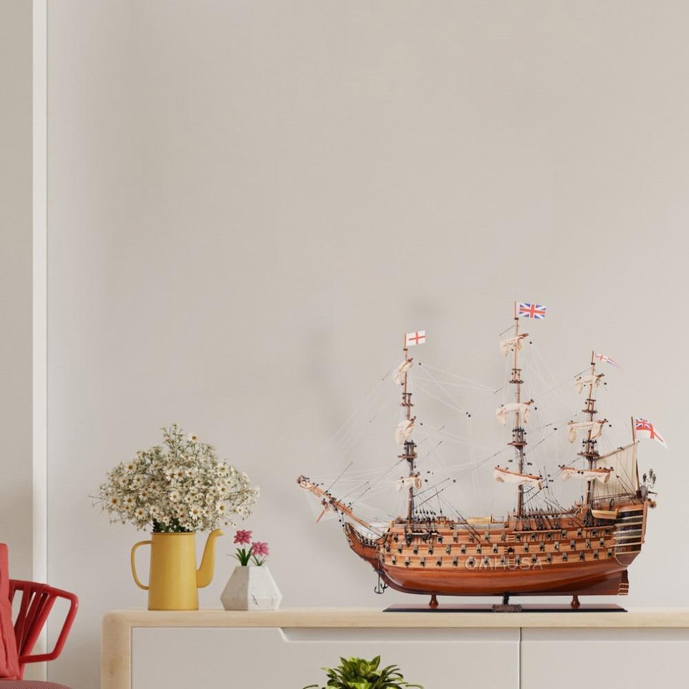 Handcrafted Vintage H.M.S. Victory Model: Handcrafted Vintage H.M.S. Victory Model This handcrafted model of the H.M.S. Victory showcases exceptional craftsmanship, reflecting a vintage nautical style. The model features a detailed wooden hul