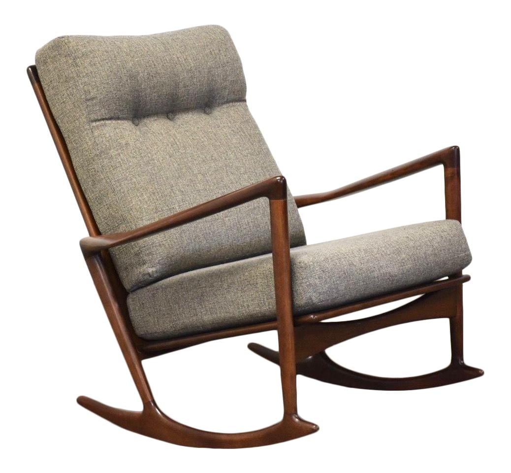 Ib Kofod Larsen Mid-Century Walnut Rocking Chair with Gray Upholstery: Ib Kofod Larsen Mid-Century Walnut Rocking Chair with Gray Upholstery This mid-century modern rocking chair, designed by Ib Kofod Larsen for Selig, features a striking walnut finish complemented by st