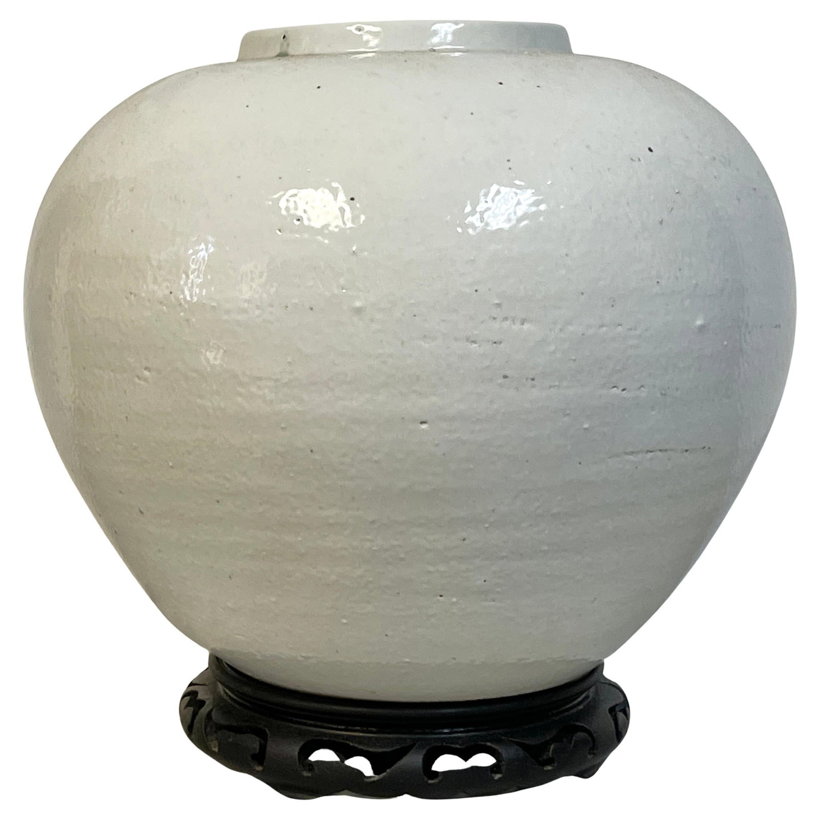 Large 20th Century Korean Porcelain Moon Jar on Wood Stand: Large 20th Century Korean Porcelain Moon Jar on Wood Stand This Large Korean Monochrome Porcelain Moon Jar on a carved wood stand is a stunning representation of 20th-century minimalist ceramic design