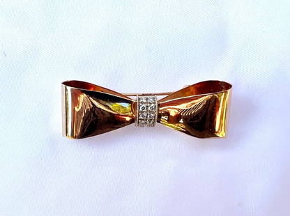 1950s French 14K Yellow Gold Diamond Bow Brooch: 1950s French 14K Yellow Gold Diamond Bow Brooch This exquisite 1950's French brooch is crafted from 14K yellow gold and features a stunning diamond bow design. Measuring 1.70" in length, 0.55" in widt