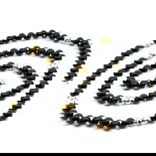 Elegant 28 Inch Black Onyx Necklace with 14K Yellow Gold Accents: Elegant 28 Inch Black Onyx Necklace with 14K Yellow Gold Accents This elegant 28-inch long beaded necklace features striking black onyx stones, complemented by 14k yellow gold bead stations and a clas