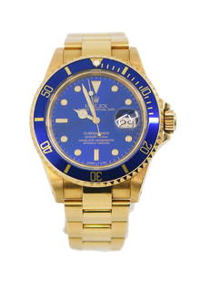 Rolex Submariner 18K Yellow Gold Watch Blue Dial 16618: Rolex Submariner 18K Yellow Gold Watch Blue Dial 16618 Experience the elegance of the Rolex Submariner, a stunning wristwatch crafted from 18K yellow gold. This pre-owned timepiece features a striking
