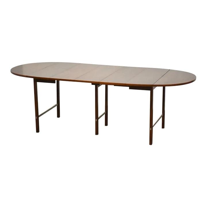 Mid-Century Modern Paul McCobb Walnut Drop Leaf Dining Table 90.25": Mid-Century Modern Paul McCobb Walnut Drop Leaf Dining Table 90.25" This exquisite mid-century modern dining table, designed by Paul McCobb for Calvin, showcases a stunning walnut finish complemented