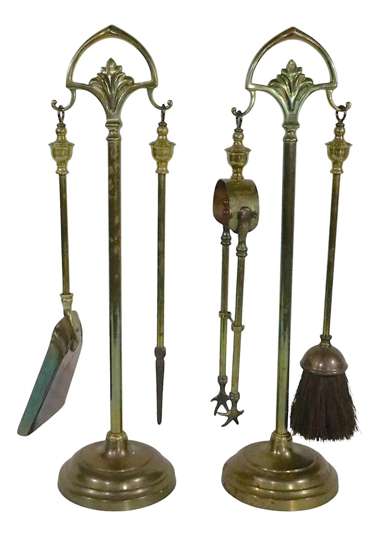2 Matching Antique Brass Tool Sets: 2 Matching Antique Brass Tool Sets Discover this elegant suite of two matching antique brass fireplace tool sets, each comprising one stand and two tools. One set features a brush and tongs, while the