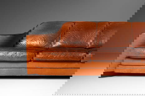 Vintage 1970s Art Deco Mid-Century Modern Sofa in Patinaed Leather 90.5": Vintage 1970s Art Deco Mid-Century Modern Sofa in Patinaed Leather 90.5" This Art Deco Mid-Century Modern three-seater sofa boasts a striking design with sculptural arms and a unique patinaed leather