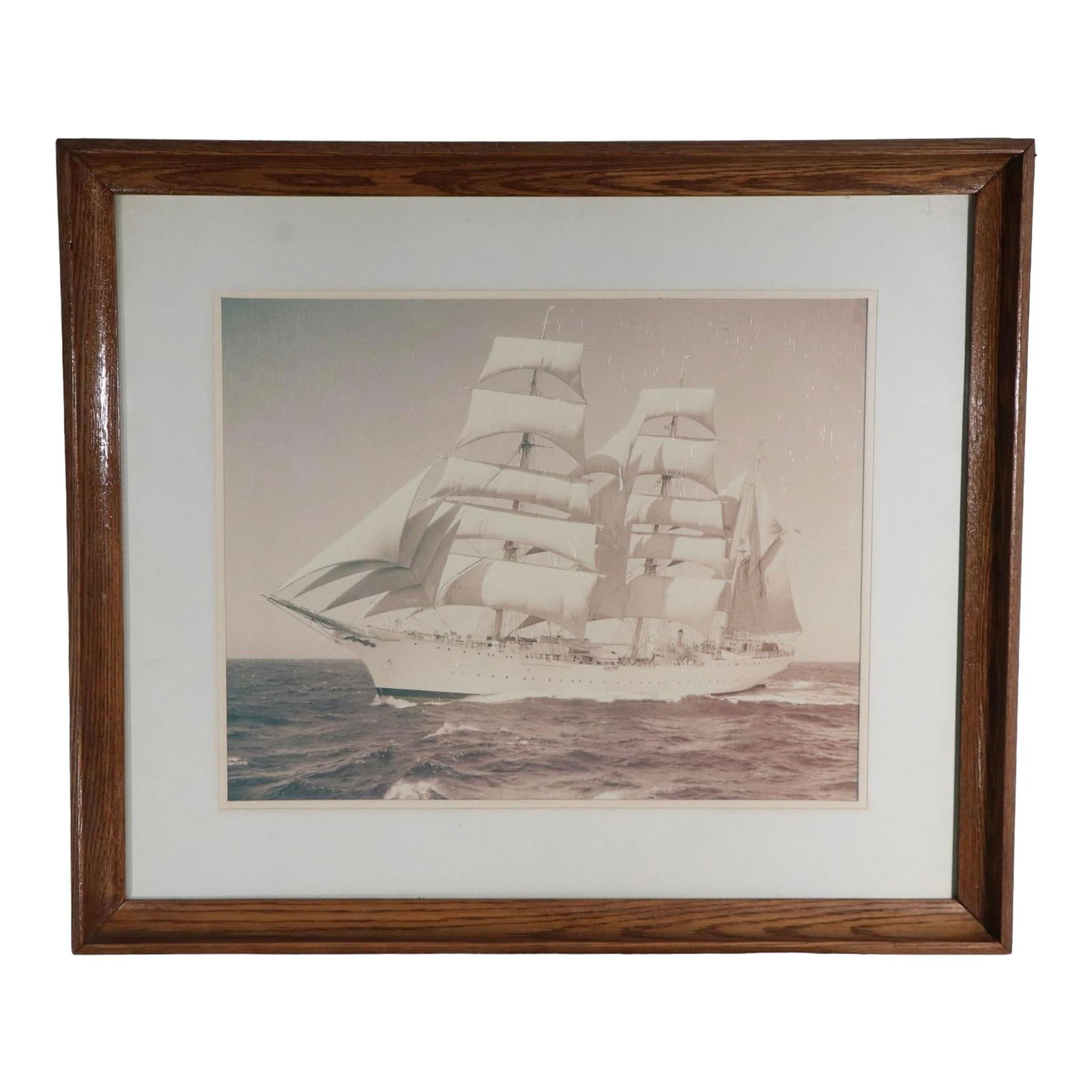 Vintage 1957 Nautical Photograph of Sailing Ship in Oak Frame: Vintage 1957 Nautical Photograph of Sailing Ship in Oak Frame Charming silver gelatin photograph of a ship in full sail, framed, matted, and under glass, dated 1957. This decorative piece is in good,