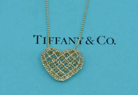 Tiffany & Co 18K Yellow Gold Heart Pendant Necklace Authentic Love Theme: Tiffany & Co 18K Yellow Gold Heart Pendant Necklace Authentic Love Theme This exquisite Tiffany & Co. necklace features a stunning heart-shaped pendant crafted from 18K yellow gold, embodying the them