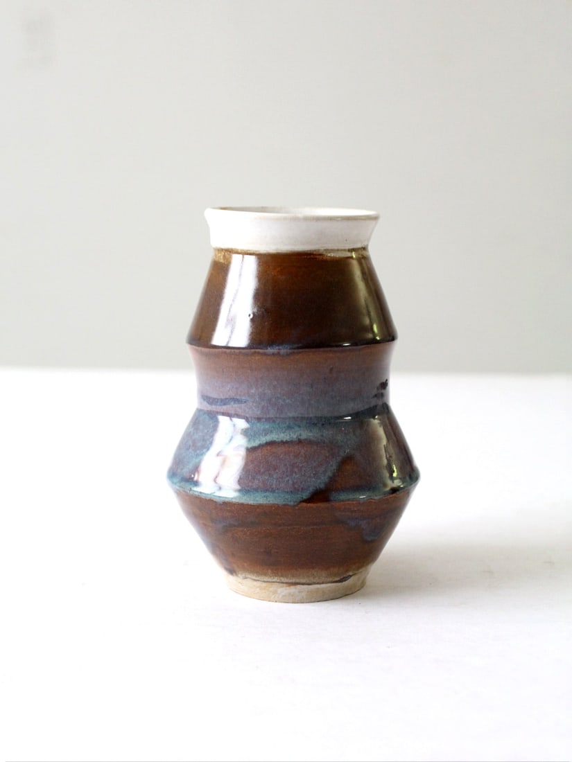 Signed Vintage Handmade Pottery Vase 7.25 inches Dynamic Glaze: Signed Vintage Handmade Pottery Vase 7.25 inches Dynamic Glaze This vintage studio pottery vase showcases a unique handmade design with a dynamic tiered structure. The vase features a stunning glaze i