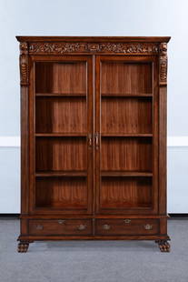 Lion Carved Bookcase in Traditional Mahogany Finish: Lion Carved Bookcase in Traditional Mahogany Finish This elegant mahogany bookcase showcases exquisite carved details, including lion heads and claw feet, embodying the timeless Chippendale style. Cra