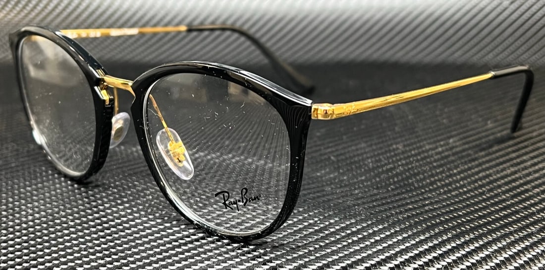 Ray Ban RX7140 2000 Black Gold Women's Eyeglasses with Case: Ray Ban RX7140 2000 Black Gold Women's Eyeglasses with Case Discover the stylish Ray Ban RX7140 2000 eyeglasses, designed for women with a chic black and gold color scheme. These fashionable frames fe