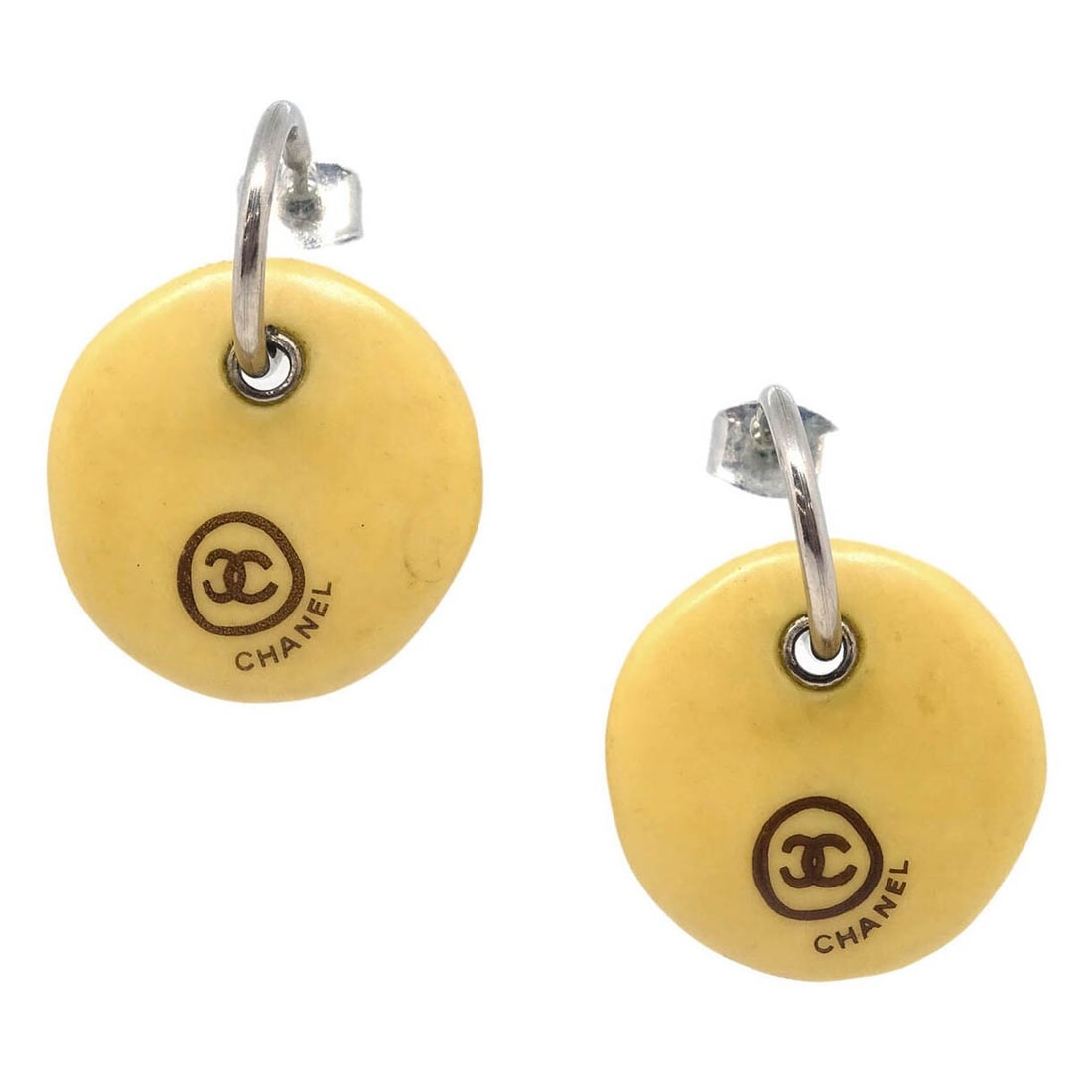 Chanel Beige Silver Dangle Button Piercing Earrings: Chanel Beige Silver Dangle Button Piercing Earrings Elevate your accessory collection with these stunning Chanel Dangle Piercing Earrings. Crafted with a chic button style, these earrings feature a be