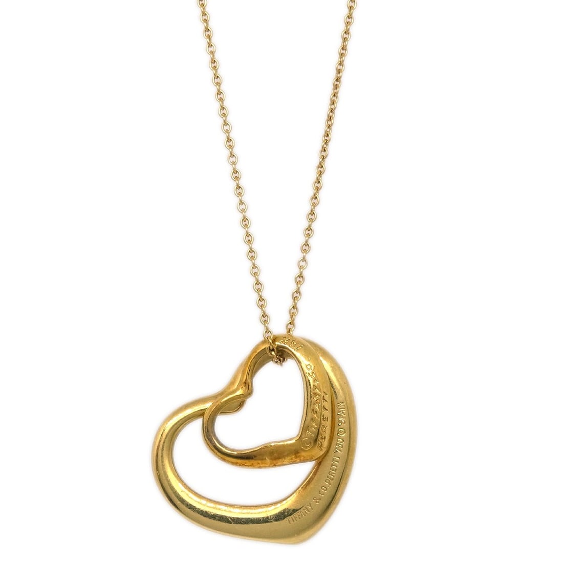 Tiffany & Co. 18K Gold Open Heart Charm Pendant Necklace: Tiffany & Co. 18K Gold Open Heart Charm Pendant Necklace This elegant Tiffany & Co. Open Heart Pendant Necklace is crafted from high-quality 18K gold, showcasing a stylish charm design. The necklace f