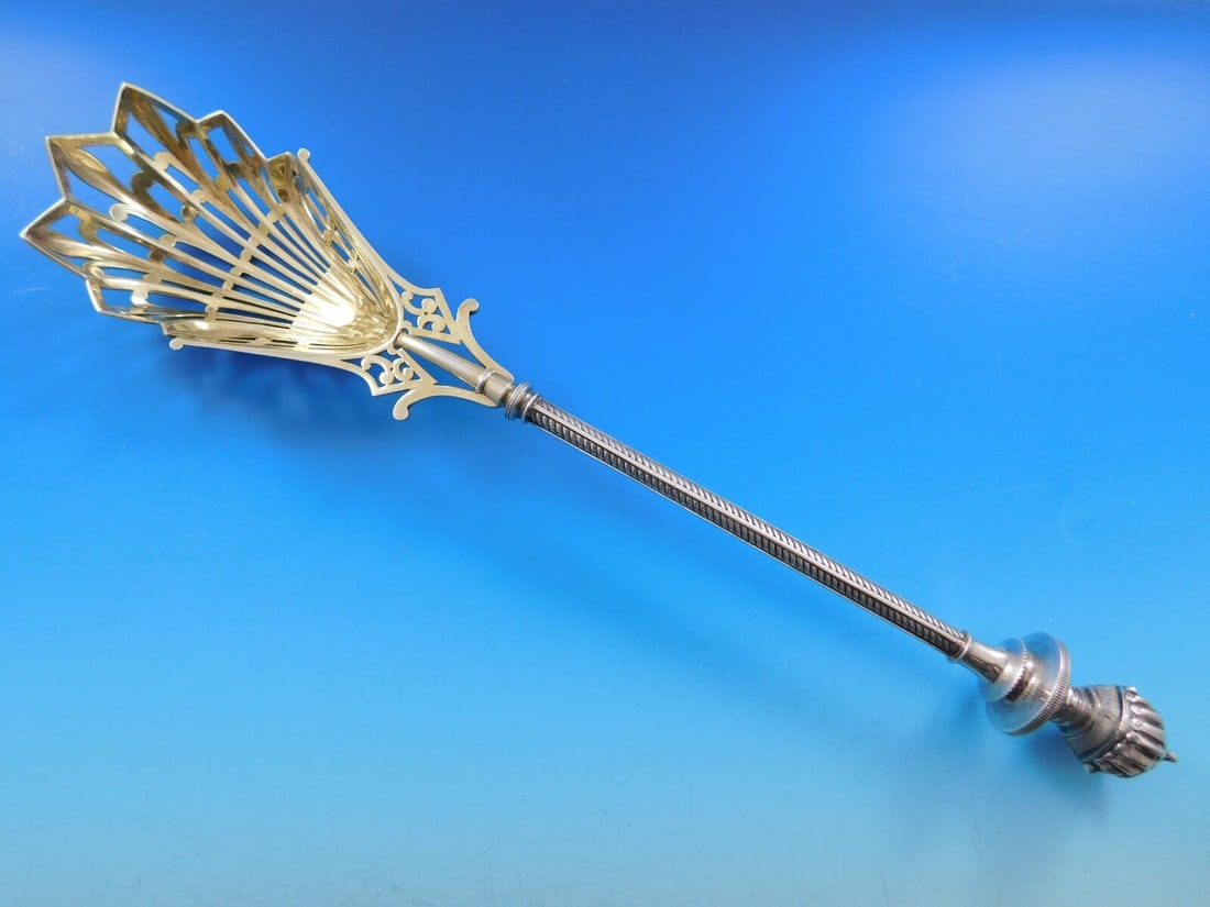 George Sharp Sterling Silver Ice Spoon 11 3/4" 3D Helmet Lizard Finial: George Sharp Sterling Silver Ice Spoon 11 3/4" 3D Helmet Lizard Finial This exquisite ice spoon from George Sharp is crafted from sterling silver and features a beautifully pierced bowl, adorned with