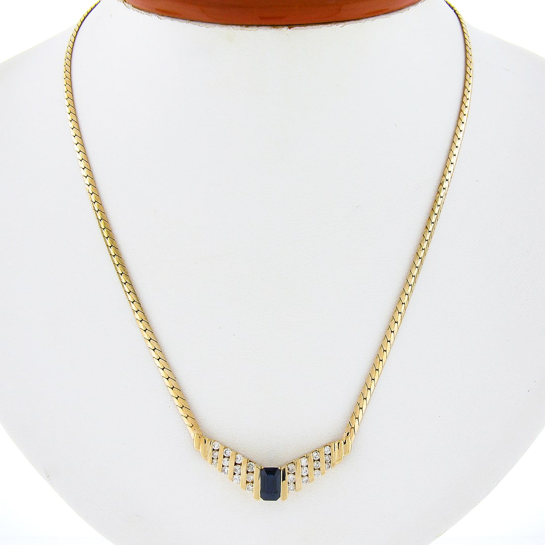 Elegant 17" 14k Yellow Gold Sapphire Diamond Chevron Necklace: Elegant 17" 14k Yellow Gold Sapphire Diamond Chevron Necklace This exquisite 17-inch necklace features a stunning combination of a natural emerald cut sapphire and round brilliant diamonds, all set in
