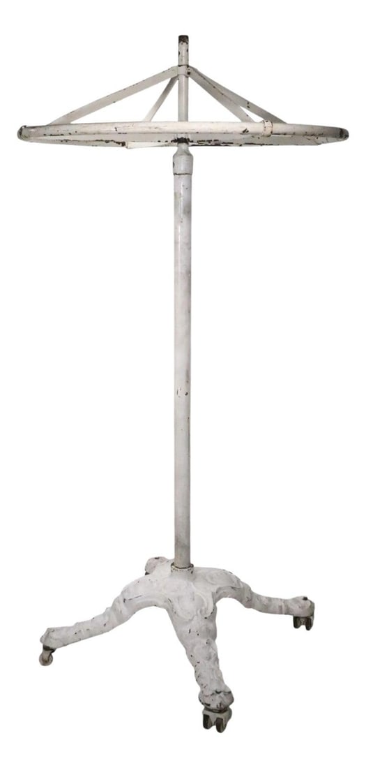 Victorian Cast Iron Revolving Coat Rack with Wheels 30" Top Diameter: Victorian Cast Iron Revolving Coat Rack with Wheels 30" Top Diameter Unusual Victorian cast iron industrial coat rack, on wheel coaster feet. The stand features a revolving ring top, tubular steel cen