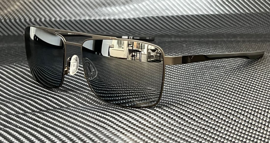 PUMA PU0222S 001 Ruthenium Black Silver Polarized Men's Sunglasses: PUMA PU0222S 001 Ruthenium Black Silver Polarized Men's Sunglasses Elevate your style with the PUMA PU0222S 001 Men's Sunglasses. Featuring a sleek ruthenium black frame complemented by silver polariz
