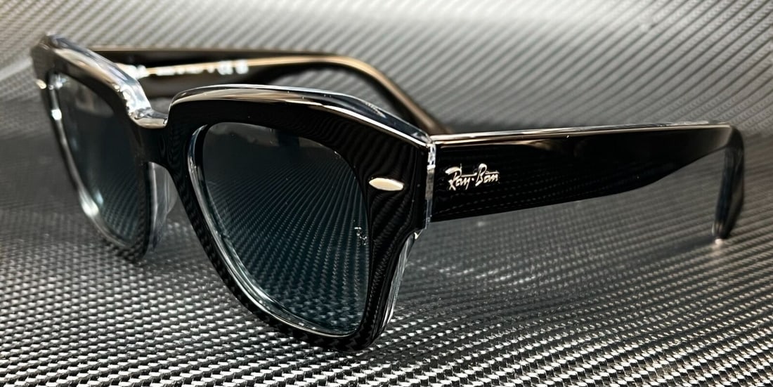Ray-Ban RB2186 12943M Black Square Sunglasses with Blue Gradient Lenses: Ray-Ban RB2186 12943M Black Square Sunglasses with Blue Gradient Lenses Discover the perfect blend of style and functionality with the Ray-Ban RB2186 12943M sunglasses. These unisex sunglasses feature