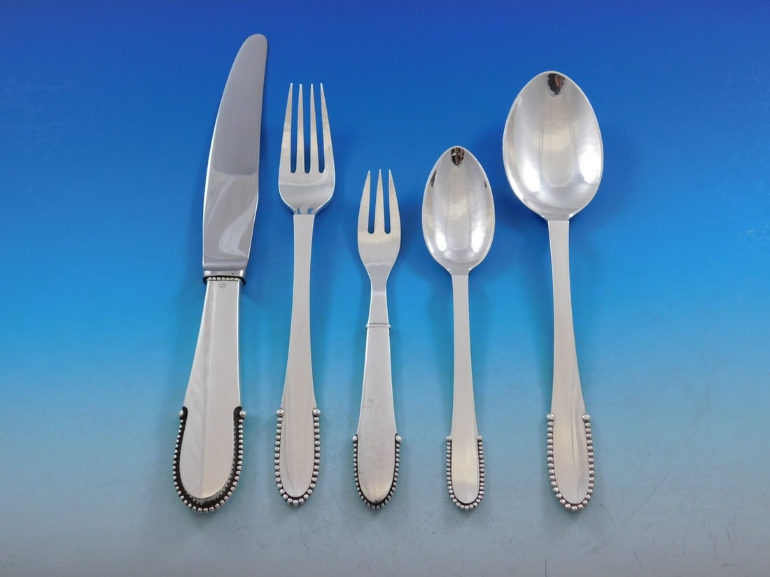 Georg Jensen Beaded Sterling Silver Flatware Set for 12 62 pcs with Storage Chest: Georg Jensen Beaded Sterling Silver Flatware Set for 12 62 pcs with Storage Chest Experience the elegance of early 20th-century design with this stunning Beaded Sterling Silver Flatware Set by Georg J