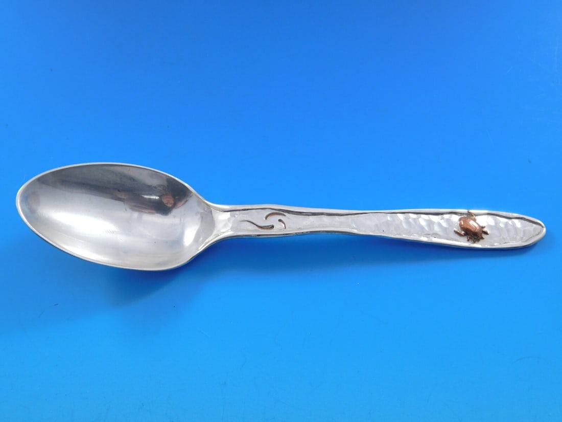 Tiffany & Co Sterling Silver Teaspoon Lap Over Edge Mixed Metals with Copper Bug: Tiffany & Co Sterling Silver Teaspoon Lap Over Edge Mixed Metals with Copper Bug This exquisite teaspoon from Tiffany & Co. showcases the unique Lap Over Edge Mixed Metals pattern. Crafted from sterli