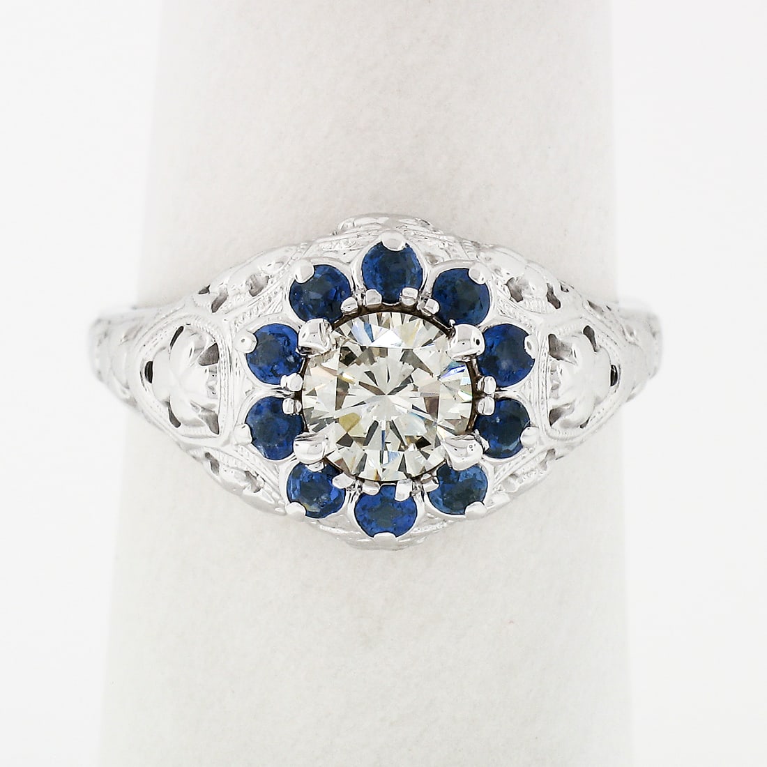 Vintage 18K White Gold Diamond Sapphire Halo Ring with Milgrain: Vintage 18K White Gold Diamond Sapphire Halo Ring with Milgrain This exquisite vintage ring is crafted from solid 18k white gold and features a stunning diamond solitaire at its center, encircled by a