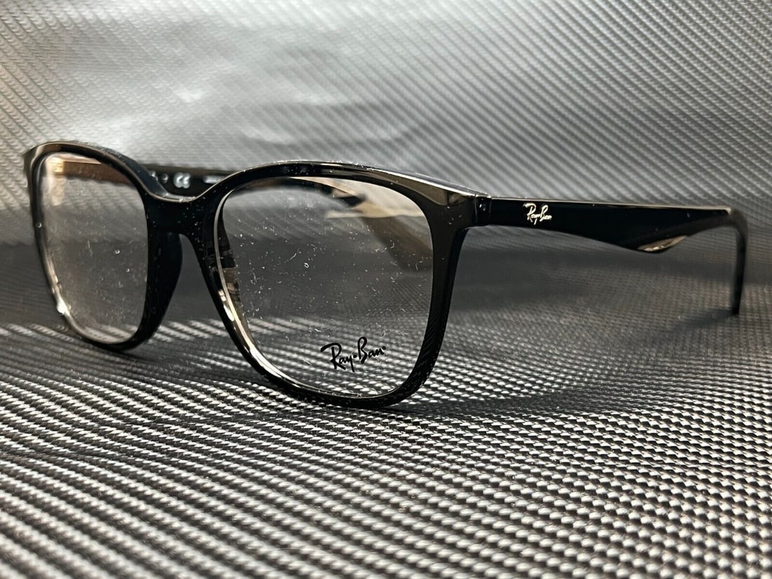 Ray-Ban RX7066 2000 Black Square Unisex Eyeglasses with Case: Ray-Ban RX7066 2000 Black Square Unisex Eyeglasses with Case Introducing the Ray-Ban RX7066 2000 eyeglasses, designed for unisex wear with a contemporary square style. These eyeglasses feature a sleek