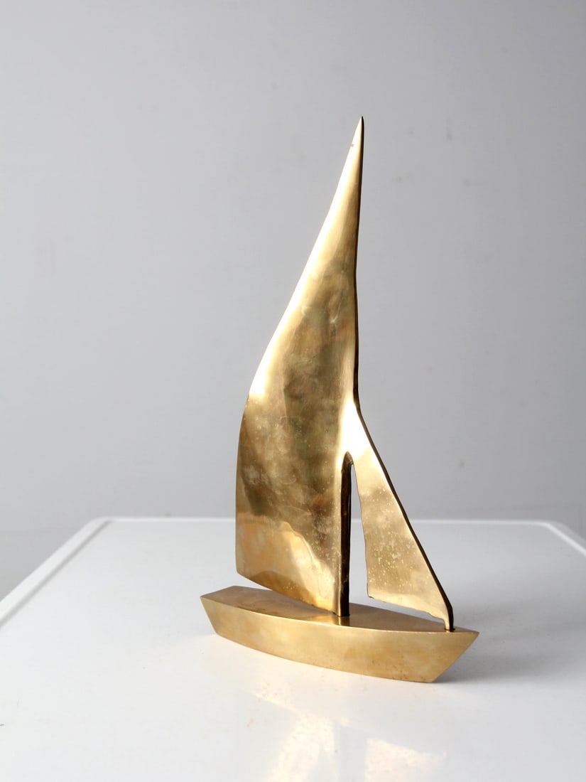 Vintage Mid-Century Brass Sailboat Figurine 16.25 Inch Coastal Decor: Vintage Mid-Century Brass Sailboat Figurine 16.25 Inch Coastal Decor Enhance your coastal decor with this stunning mid-20th century brass sailboat figurine. Featuring classic lines and a beautiful ton