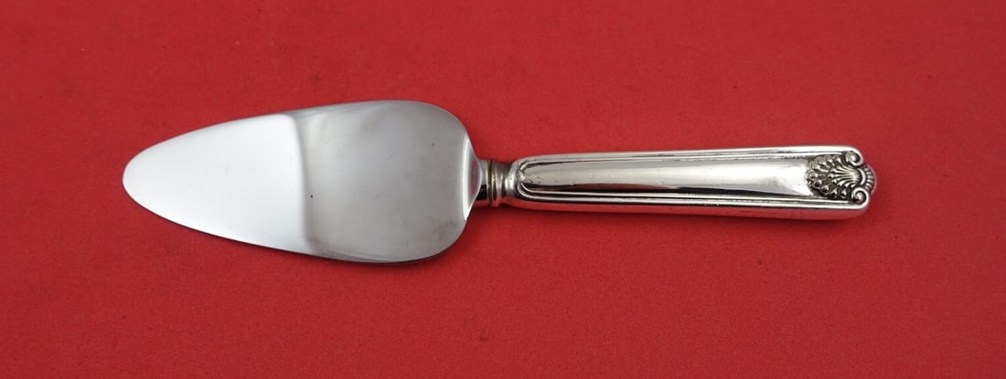 Frank Smith Fiddle Shell Sterling Silver Cheese Server 6.5": Frank Smith Fiddle Shell Sterling Silver Cheese Server 6.5" This exquisite cheese server is crafted from sterling silver and features the elegant Fiddle Shell pattern by Frank Smith. Designed with a h