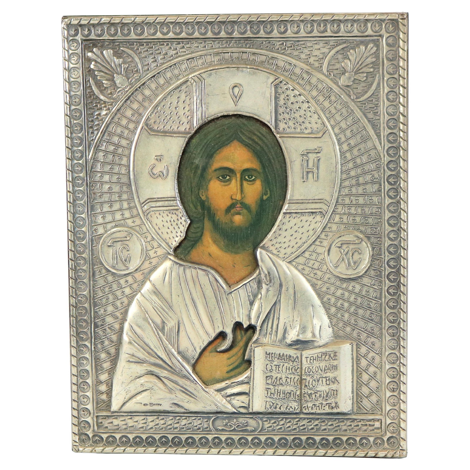 20th Century Russian Icon of Jesus in Sterling Silver Frame: 20th Century Russian Icon of Jesus in Sterling Silver Frame This exquisite Russian religious icon features a captivating portrait of Jesus Christ, beautifully encased in intricately designed sterling 