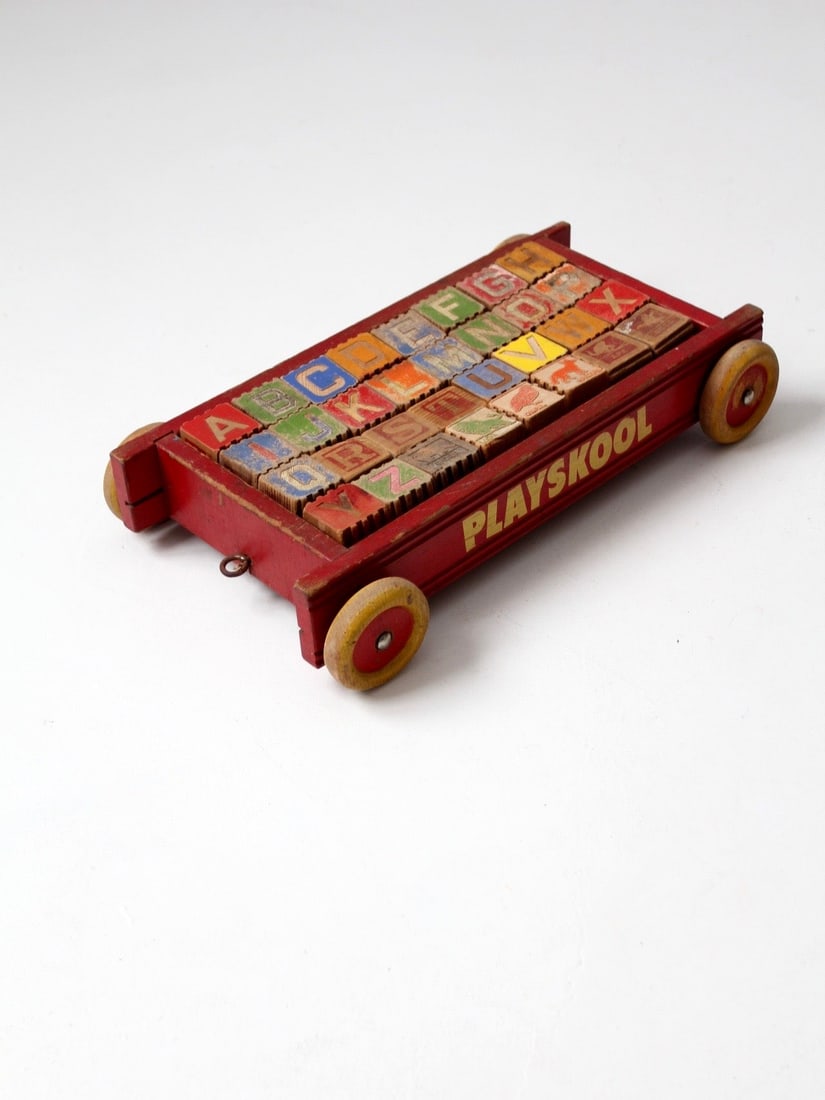 Vintage Playskool Toy Wagon with 32 Wooden Alphabet Blocks: Vintage Playskool Toy Wagon with 32 Wooden Alphabet Blocks Discover a charming vintage Playskool toy pull wagon, perfect for adding a touch of nostalgia to your home or office decor. This delightful s