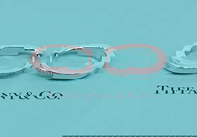 Tiffany & Co 18K White Gold Diamond Hoop Earrings Small: Tiffany & Co 18K White Gold Diamond Hoop Earrings Small Elevate your accessory collection with these exquisite Tiffany & Co. Lock Diamond Earrings, crafted from luxurious 18K white gold. These small h