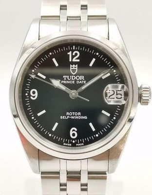 Tudor Price Date Ladies Watch Black Dial Ref 72000 with Papers 2000: Tudor Price Date Ladies Watch Black Dial Ref 72000 with Papers 2000 This Tudor Price Date watch features a striking black dial and is designed for ladies. The reference number is 72000, and it showcas