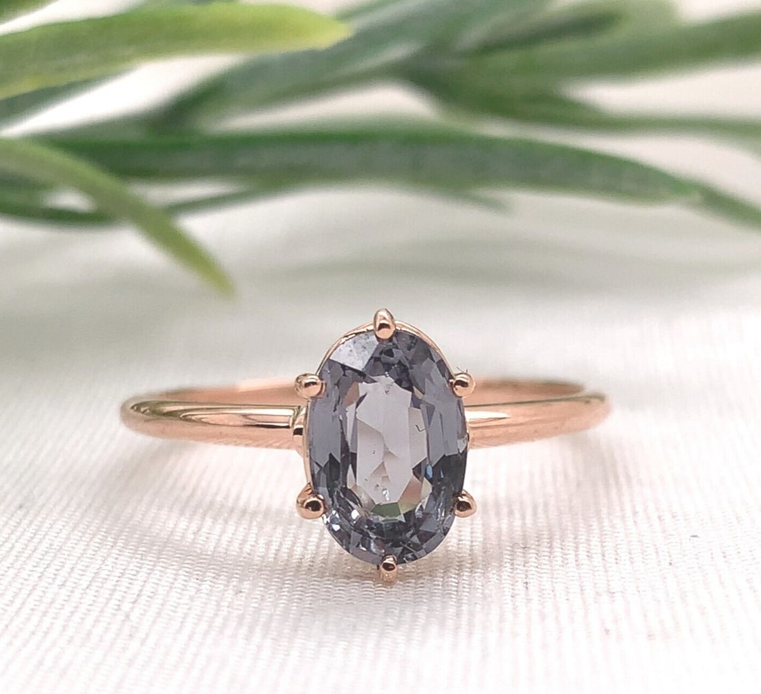 14k Rose Gold 1.76 Carat Lavender-Grey Spinel Solitaire Ring: 14k Rose Gold 1.76 Carat Lavender-Grey Spinel Solitaire Ring This stunning solitaire ring features a genuine natural spinel in a captivating lavender-grey hue, set in luxurious 14k rose gold. The oval